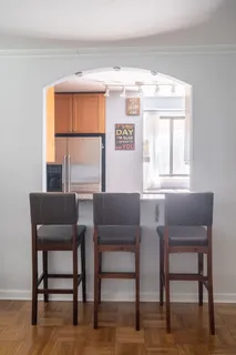 a dining room with furniture and a window