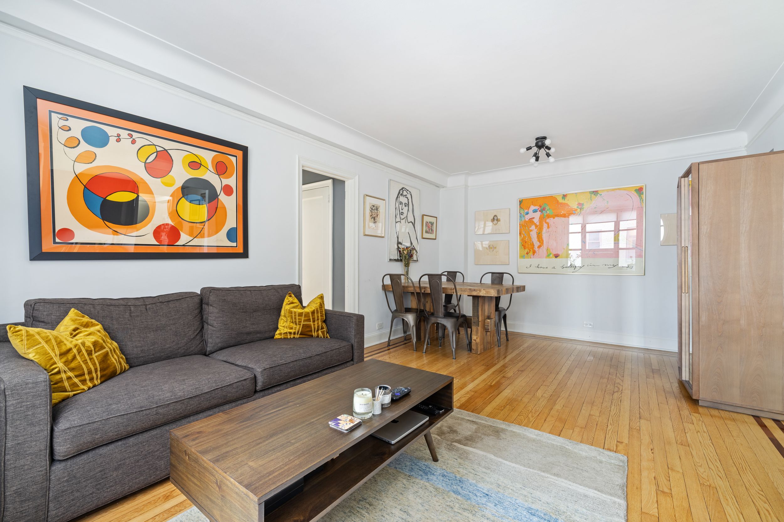235 East 22nd Street, Unit 4T Manhattan, NY 10010 - Photo 2 of 15 a living room with furniture and wooden floor