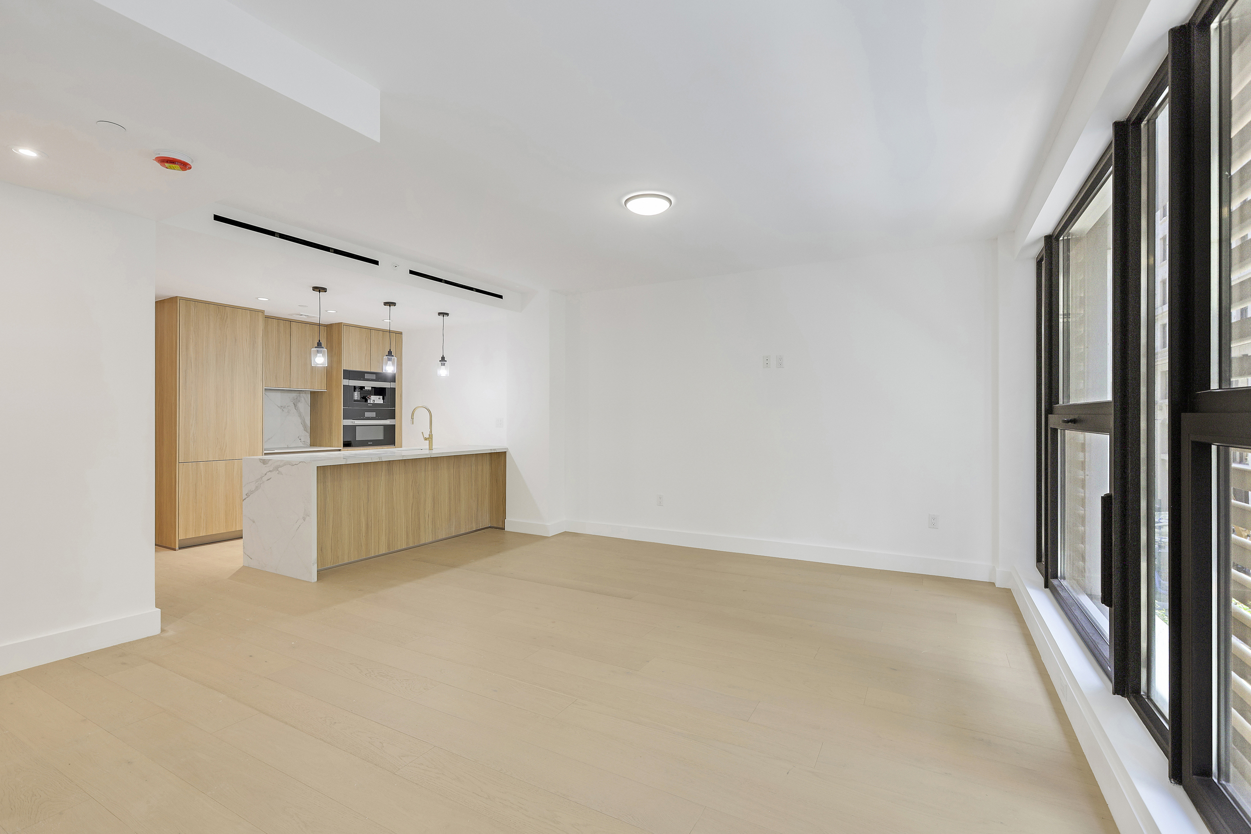 21 West 17th Street, Unit 4 Manhattan, NY 10011 - Photo 2 of 11 a view of a kitchen with refrigerator and white cabinets