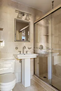a bathroom with a toilet a sink and a mirror