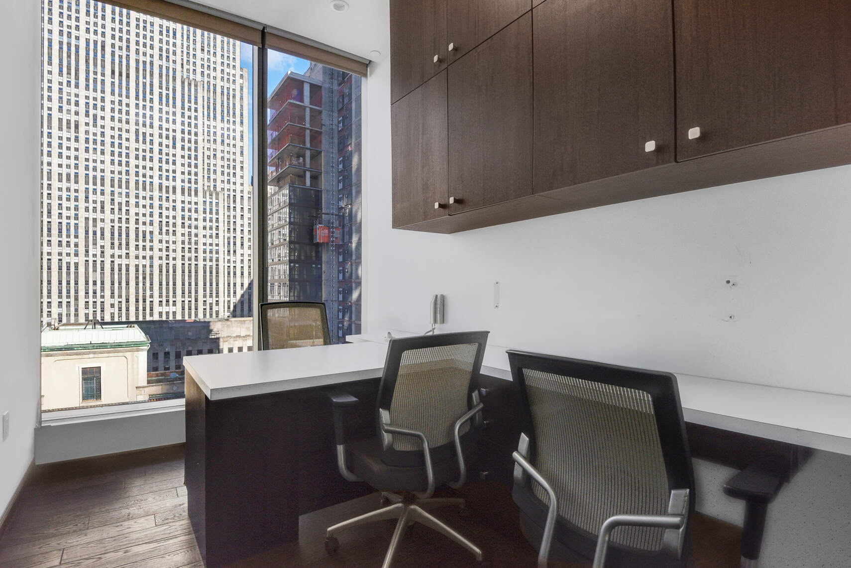 50 West 47th Street, Unit Undisclosed Manhattan, NY 10036 - Photo 26 of 27 a view of a workspace with furniture and wooden floor