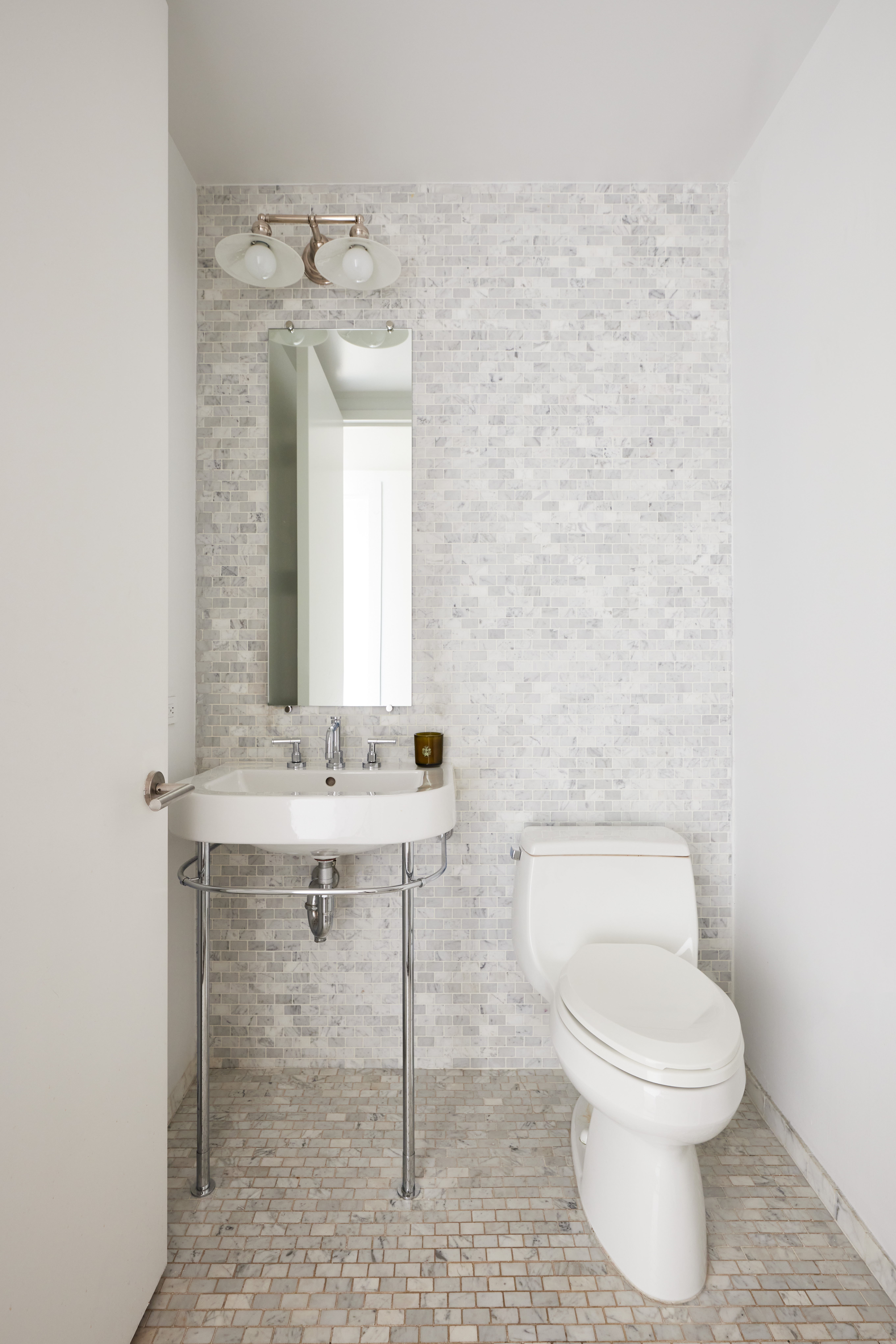 505 Greenwich Street, Unit 14A Manhattan, NY 10013 - Photo 17 of 20 a bathroom with a toilet a sink and a mirror