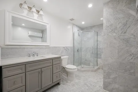 a bathroom with a bathtub shower sink and toilet