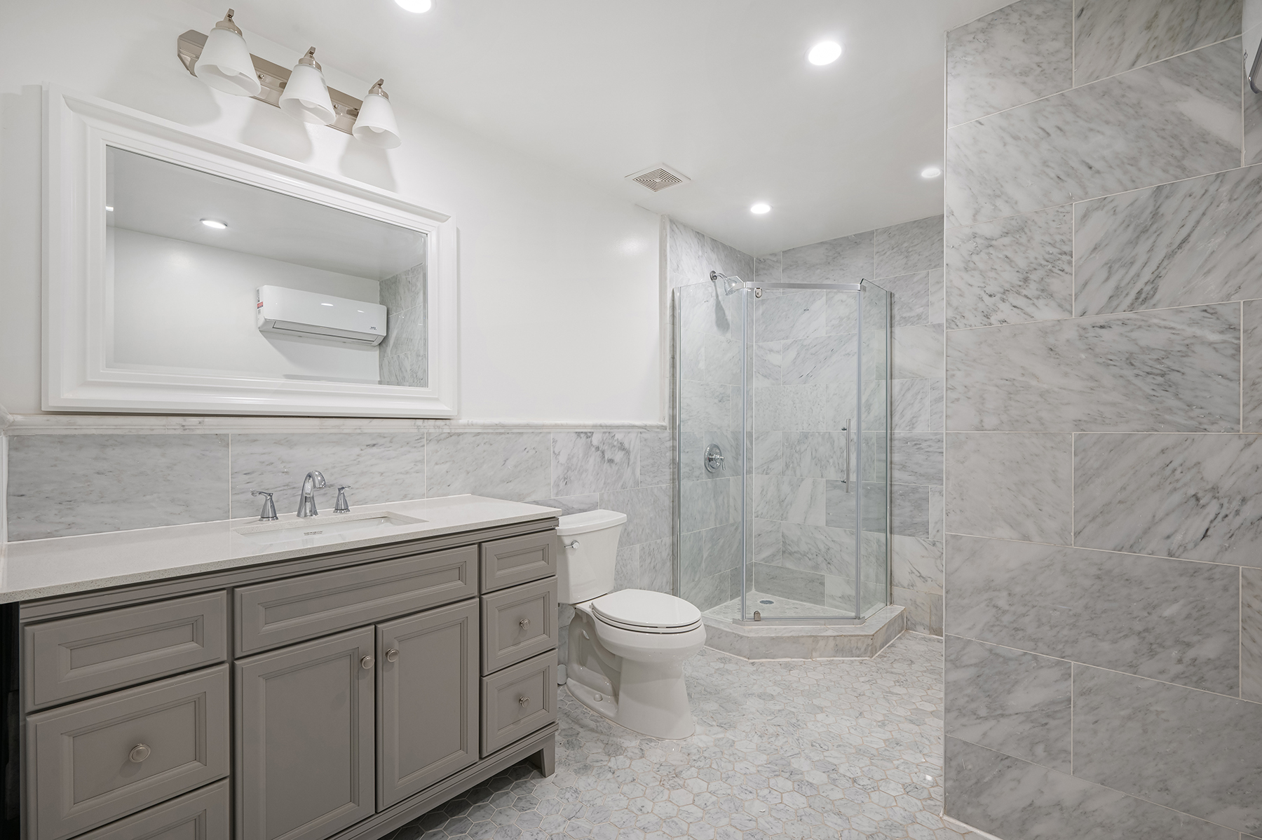 307 West 136th Street Manhattan, NY 10030 - Photo 9 of 26 a bathroom with a toilet a sink a mirror and a shower