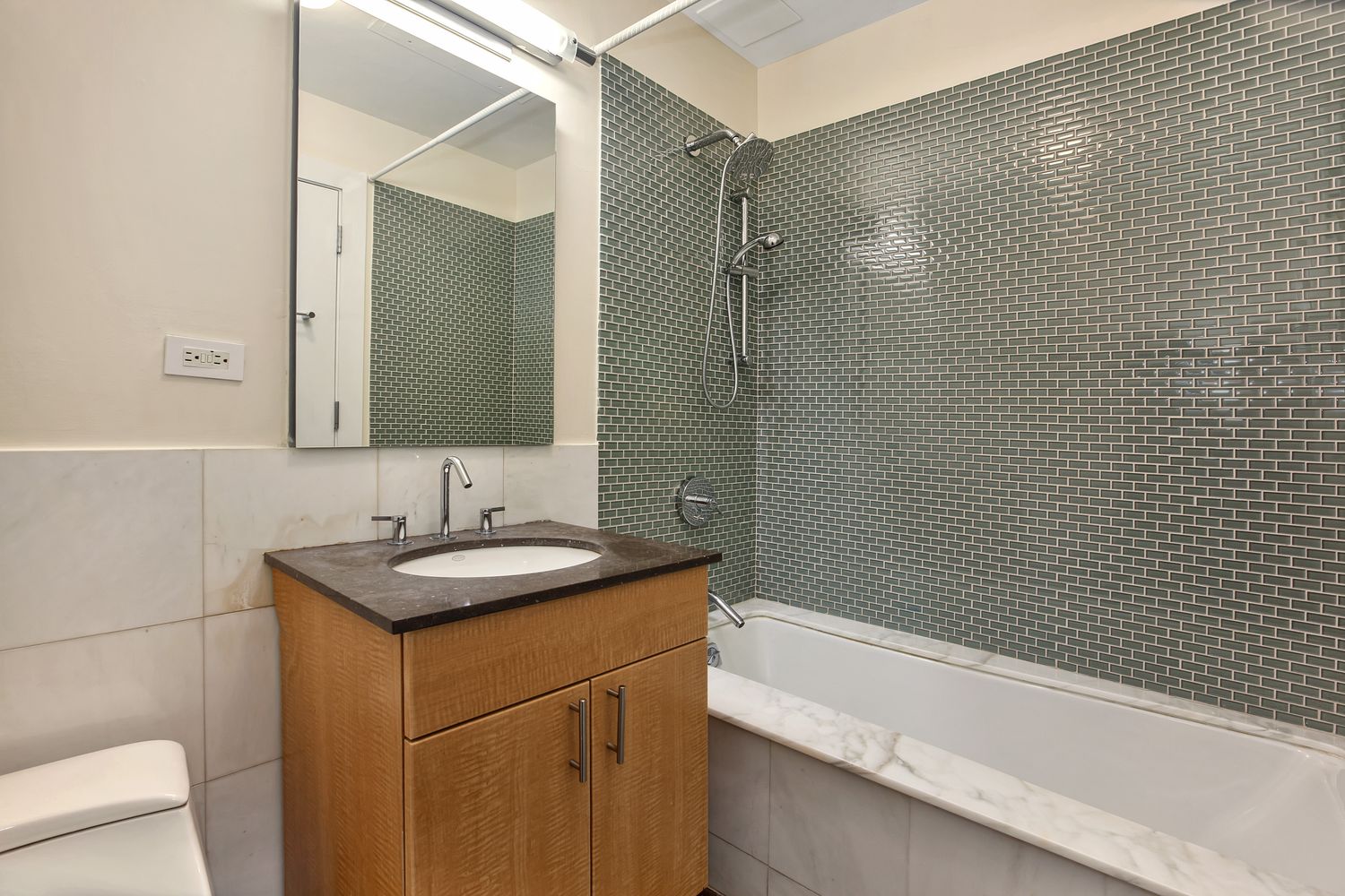 2056 5th Avenue, Unit 2B Manhattan, NY 10035 - Photo 7 of 13 a bathroom with a sink and a mirror