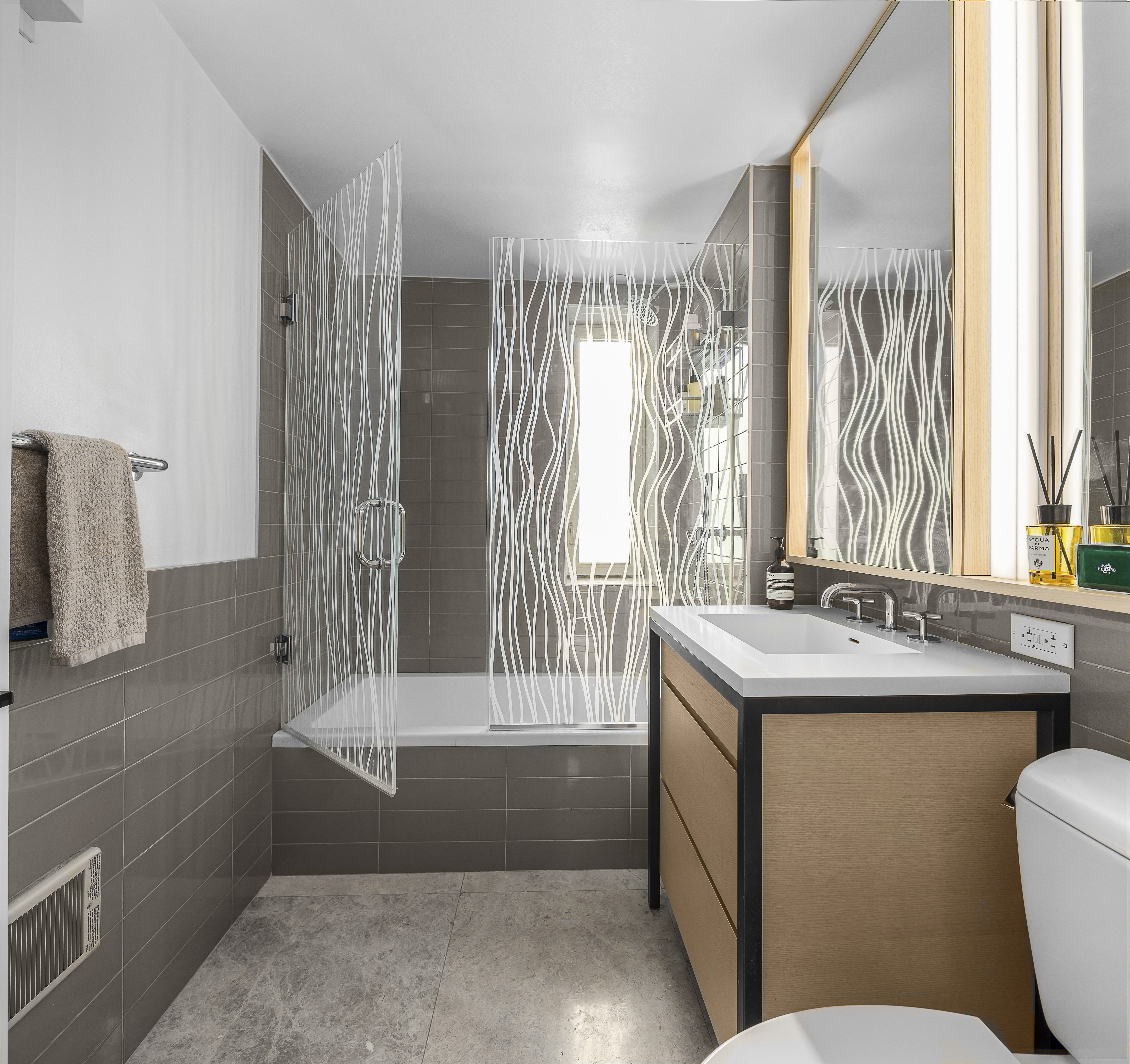 385 1st Avenue, Unit 10G Manhattan, NY 10010 - Photo 8 of 22 a bathroom with a sink toilet and shower