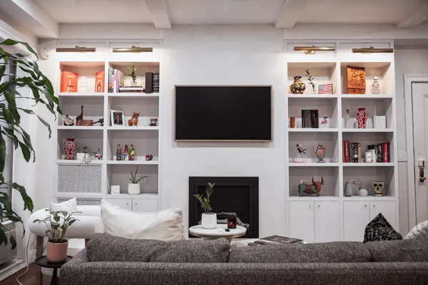 a living room with a fireplace and a flat screen tv
