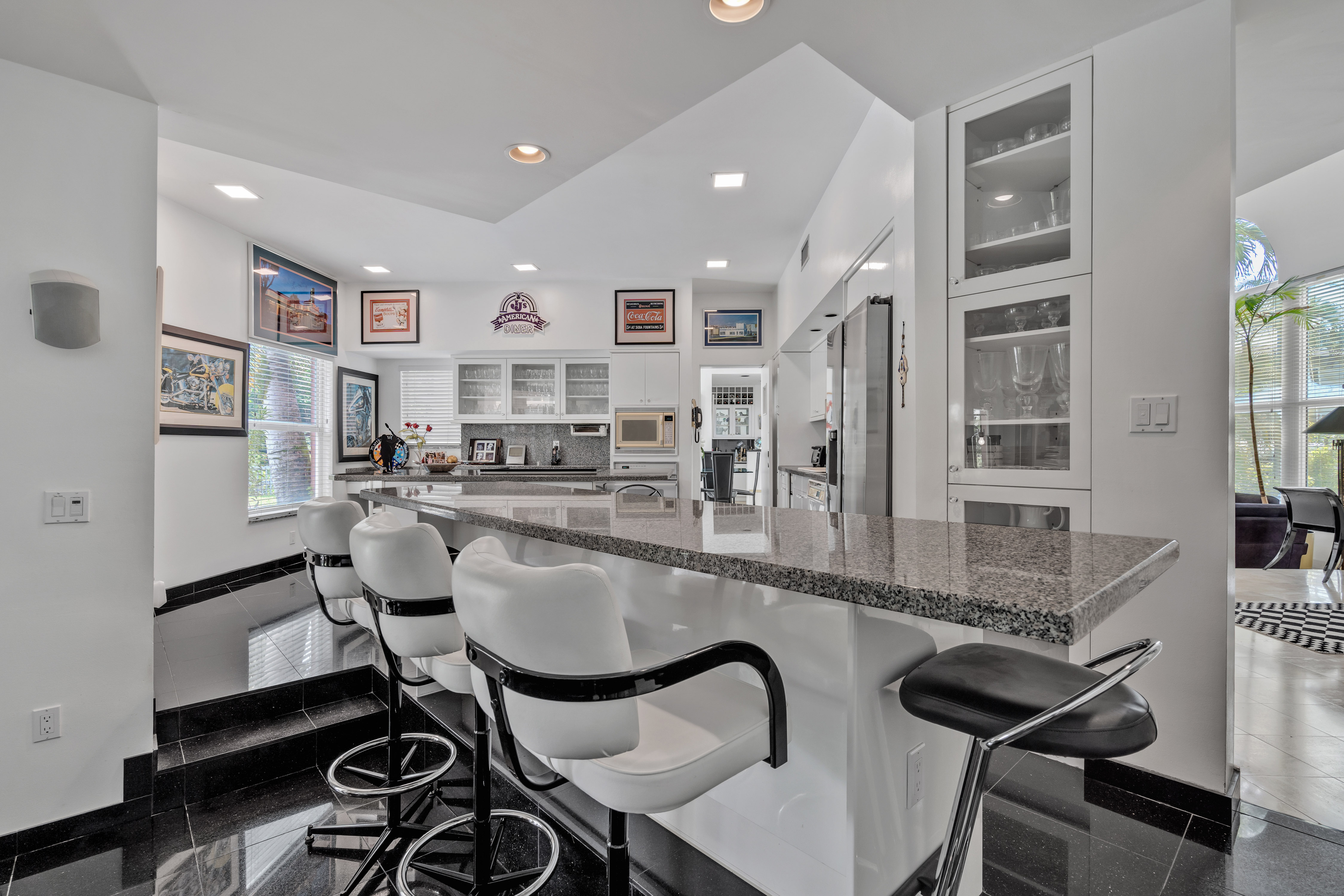8768 Southwest 62nd Court Miami, FL 33156 - Photo 22 of 56 a kitchen with stainless steel appliances granite countertop a table and chairs in it