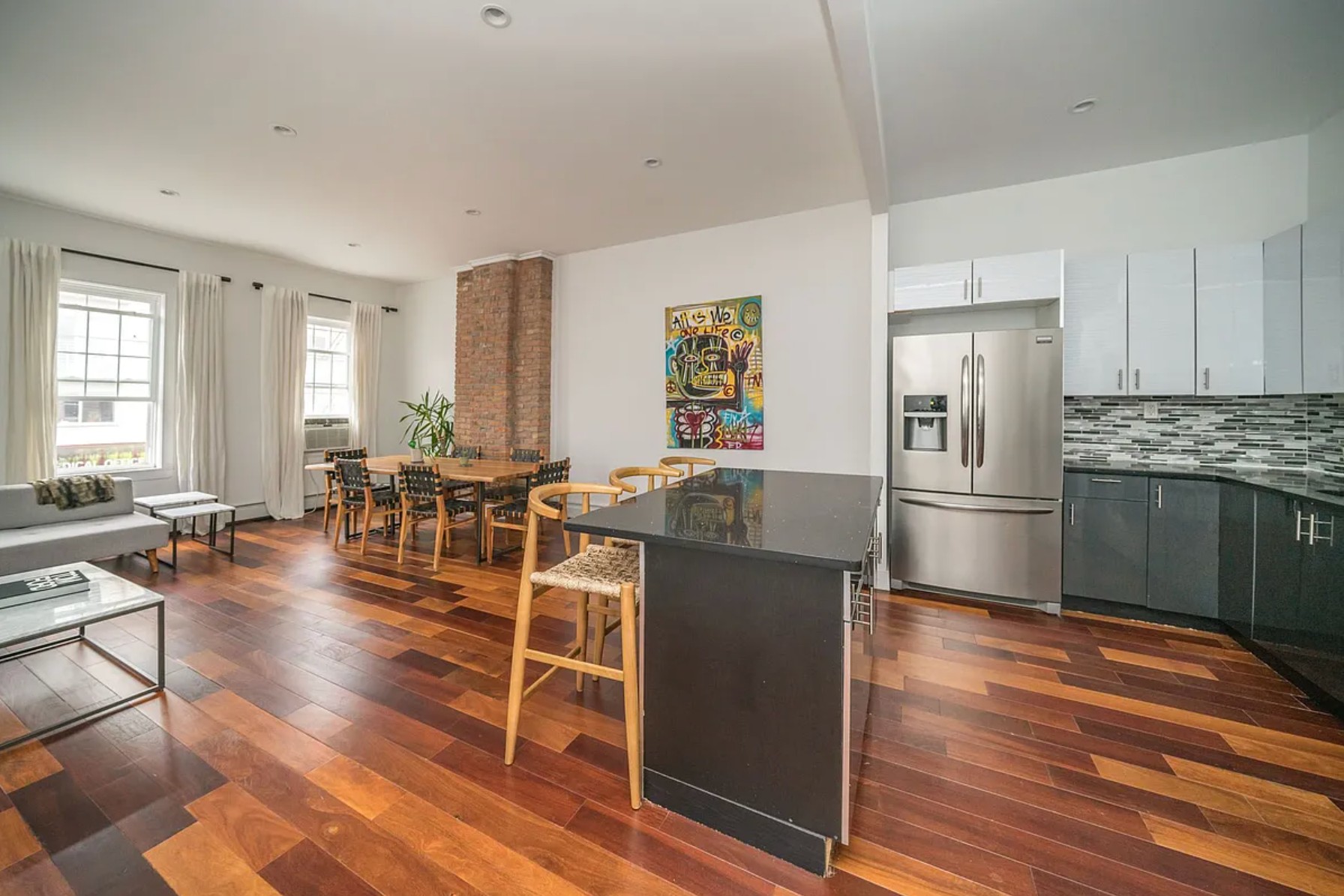 29 Melrose Street, Unit 2 Brooklyn, NY 11206 - Photo 1 of 13 a living room with furniture a wooden floor and a fireplace