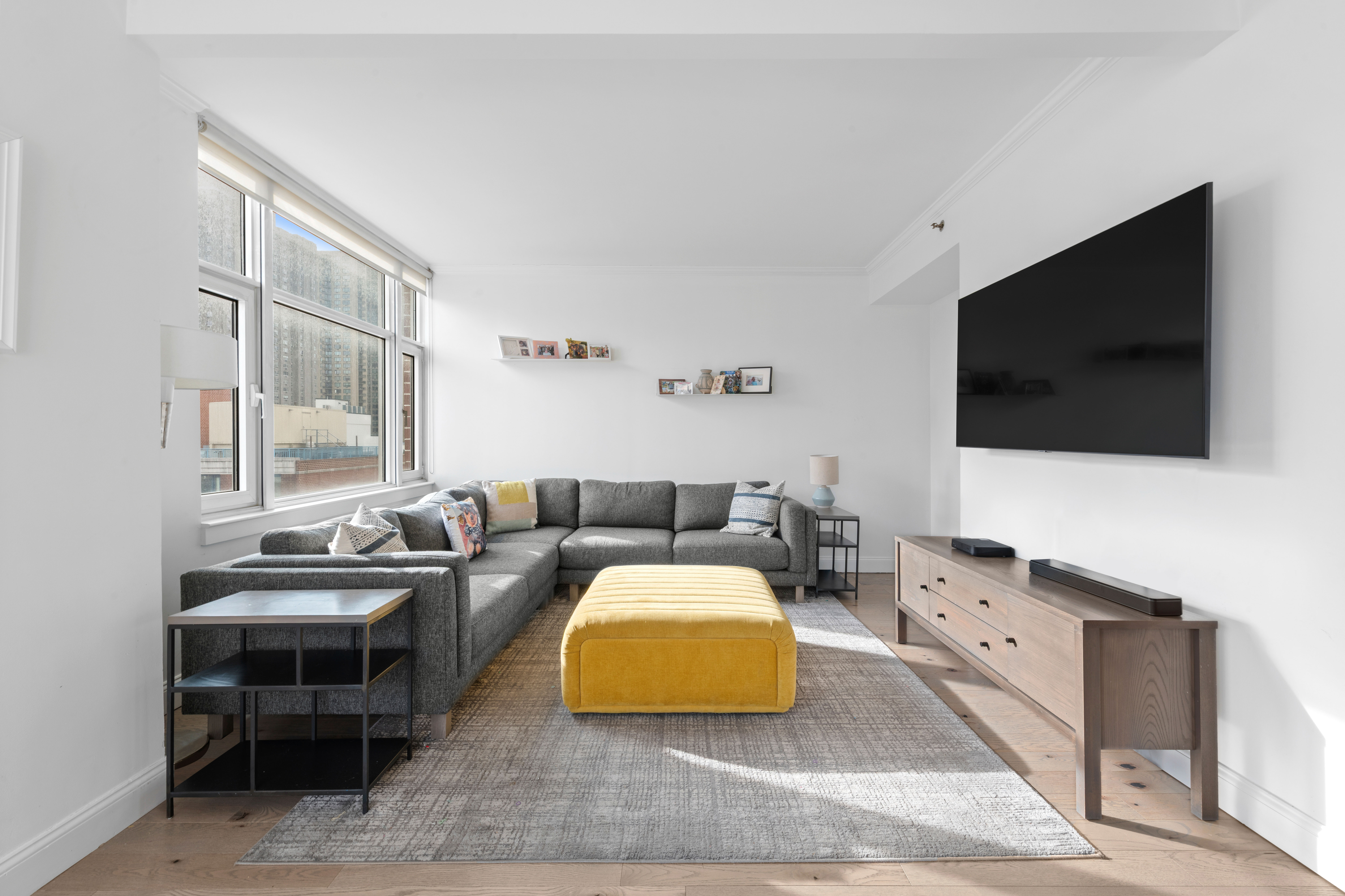 404 East 76th Street, Unit 8A Manhattan, NY 10021 - Photo 4 of 17 a living room with furniture and a flat screen tv