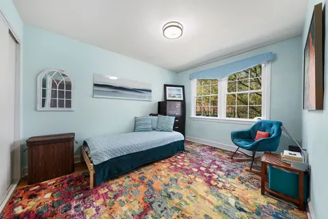 a bedroom with furniture and a window