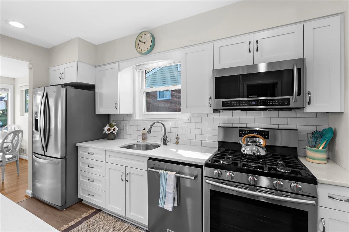 12712 Atherton Drive Silver Spring, MD 20906 - Photo 7 of 40 a kitchen with stainless steel appliances a stove microwave and a refrigerator