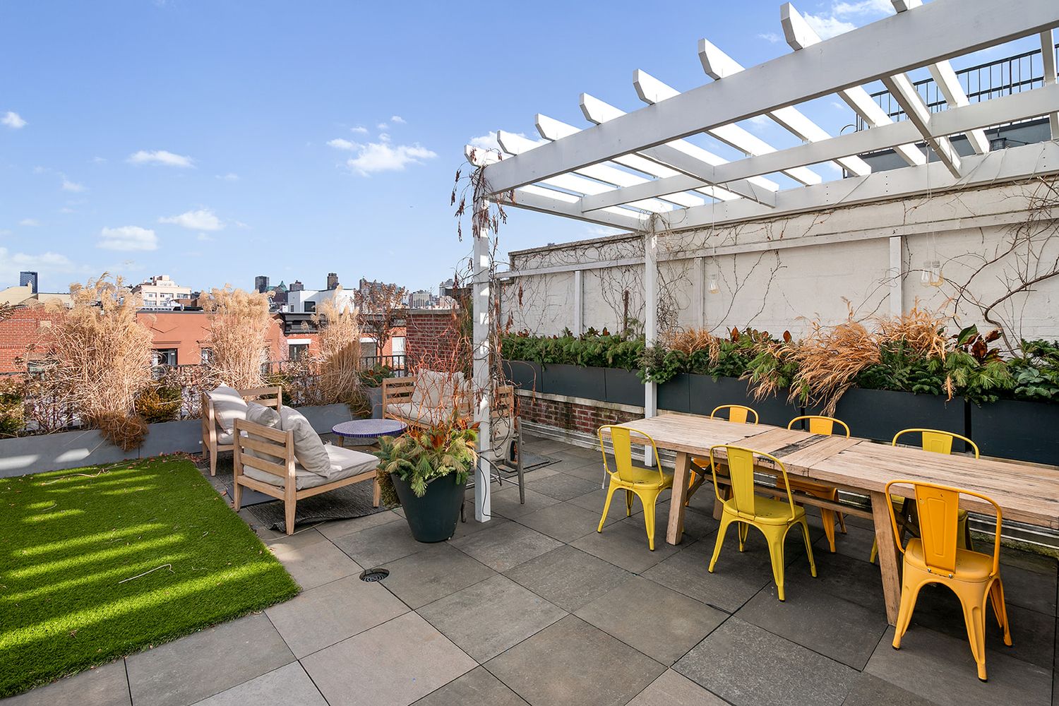a view of a patio with table and chairs potted plants with wooden floor