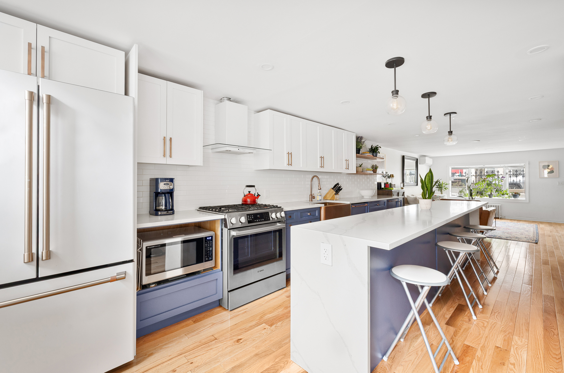 202 22nd Street Brooklyn, NY 11232 - Photo 8 of 28 a kitchen with kitchen island wooden floors appliances and white cabinets