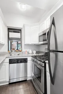 a kitchen with stainless steel appliances granite countertop a stove and a refrigerator