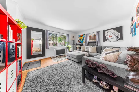 a living room with furniture a rug and a window