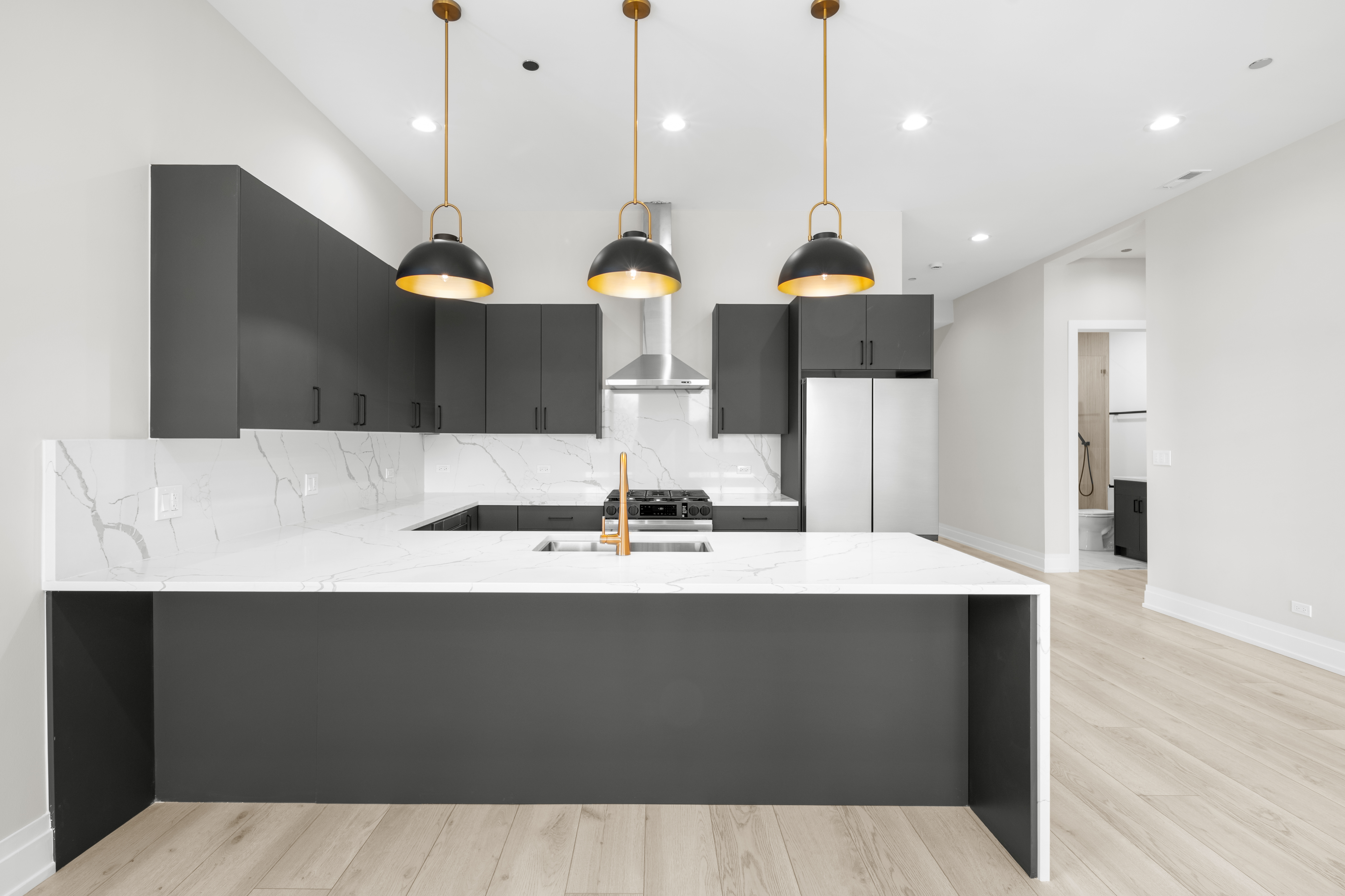 1327 West Taylor Street, Unit 4 Chicago, IL 60607 - Photo 3 of 27 a large kitchen with stainless steel appliances kitchen island a sink dishwasher a stove and a refrigerator