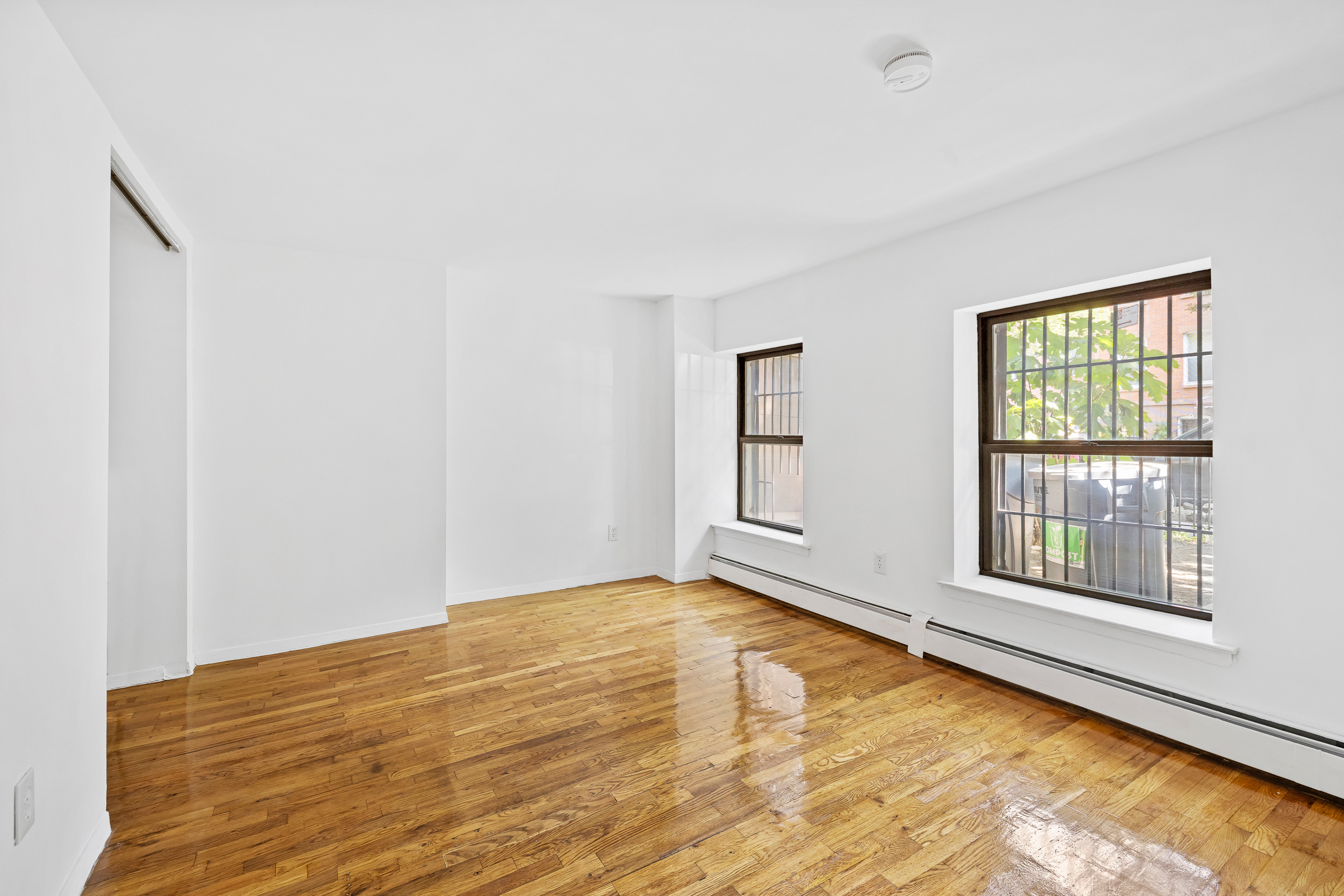 662 Warren Street Brooklyn, NY 11217 - Photo 6 of 9 a view of an empty room with wooden floor and a window