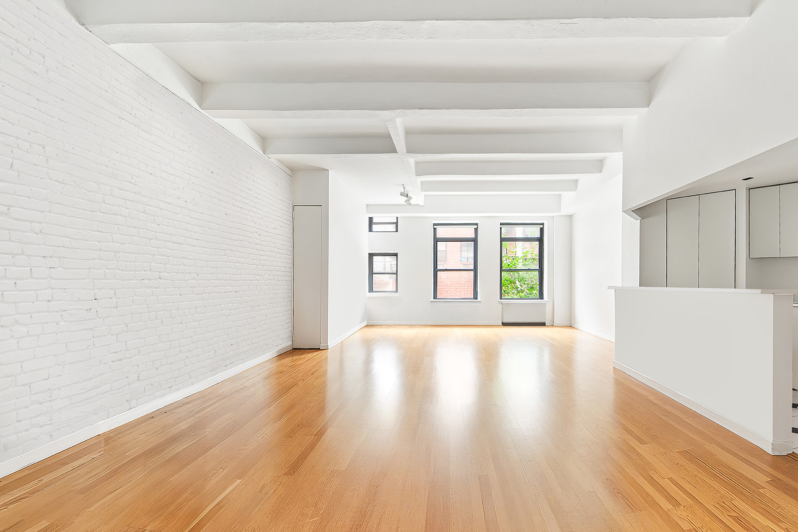 321 West 13th Street, Unit 3A Manhattan, NY 10014 - Photo 2 of 12 a view of an empty room with window and wooden floor