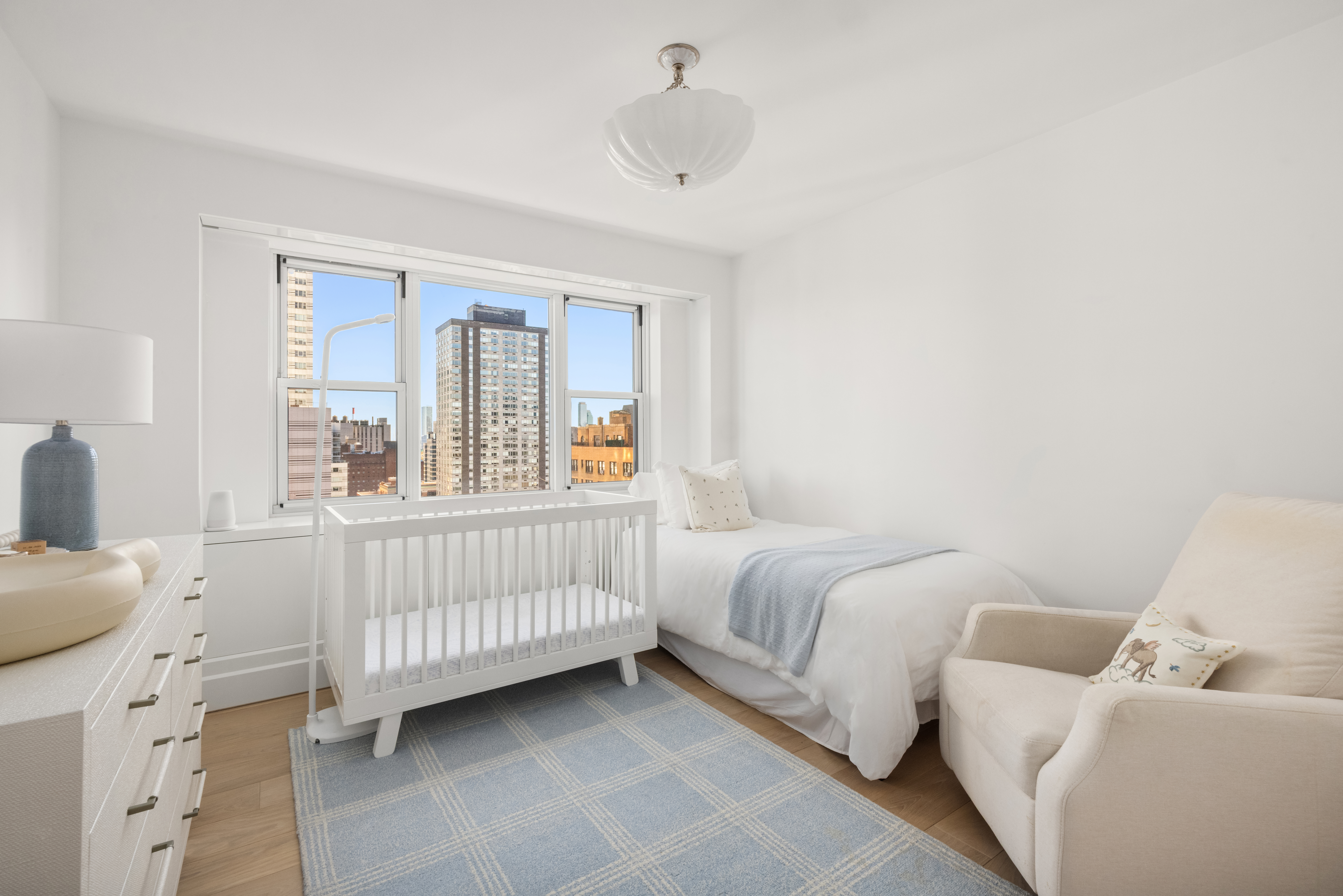 150 East 69th Street, Unit 18S Manhattan, NY 10021 - Photo 12 of 16 a bedroom with a bed and a window