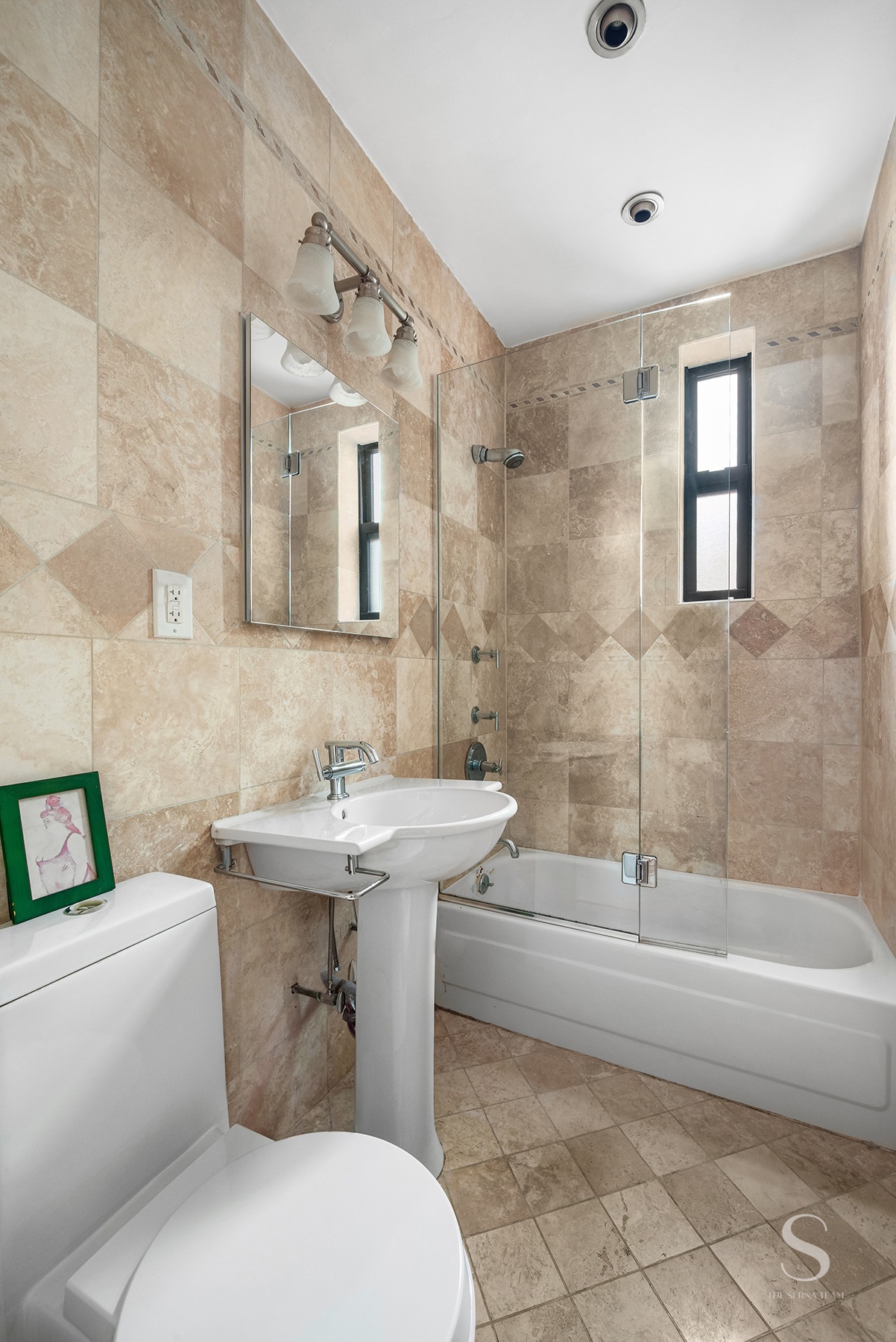 30 East 95th Street, Unit 6F Manhattan, NY 10128 - Photo 6 of 9 a bathroom with a sink toilet and shower