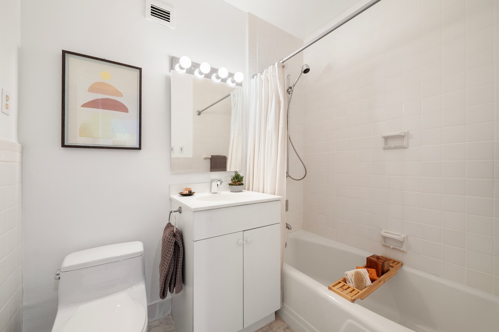 20 East 9th Street, Unit 12X Manhattan, NY 10003 - Photo 12 of 26 a bathroom with a sink a toilet and shower