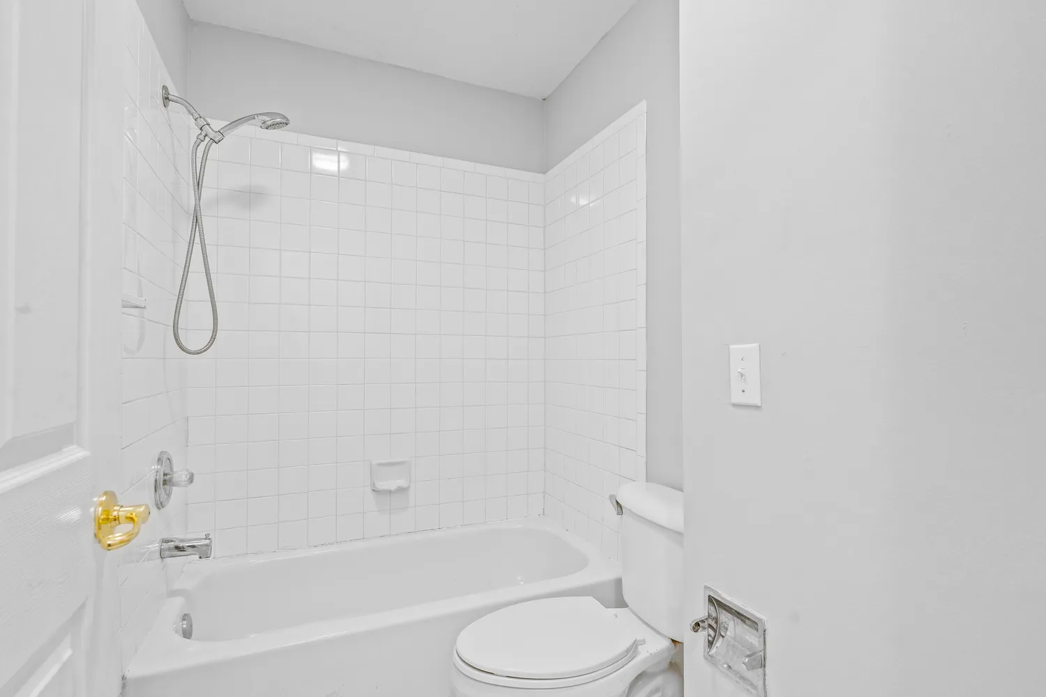 a bathroom with a shower a toilet and a bath tub