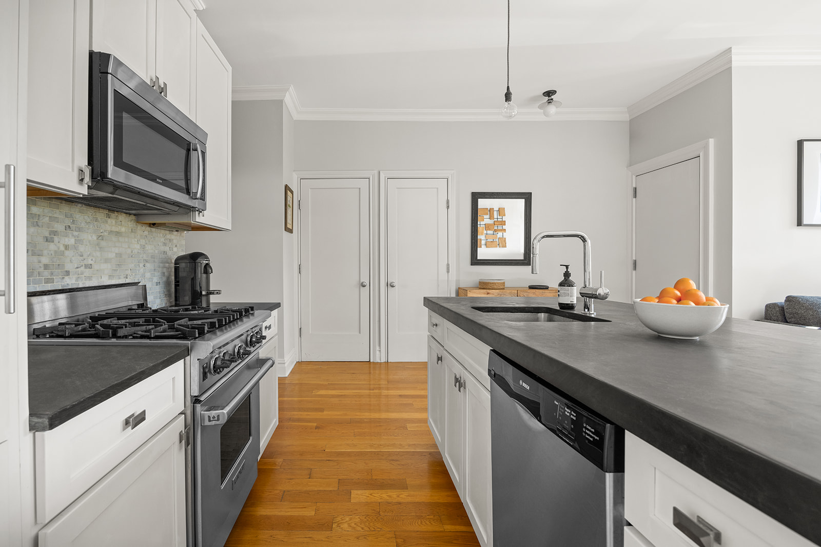 493 18th Street, Unit 2 Brooklyn, NY 11215 - Photo 5 of 13 a kitchen with stainless steel appliances granite countertop a sink stove and microwave