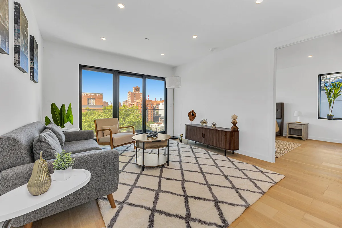 21-10 31st Avenue, Unit 6R Queens, NY 11106 - Photo 5 of 17 a living room with furniture and a large window