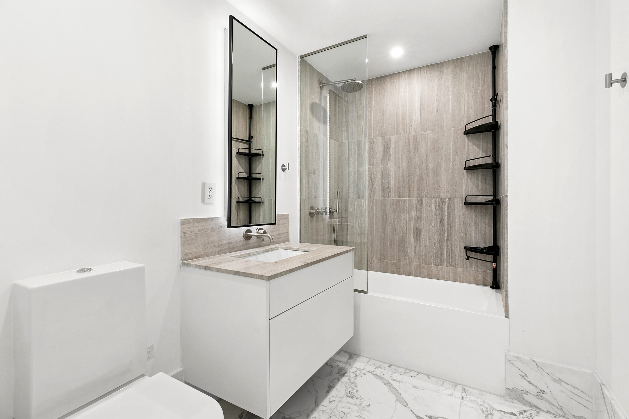 429 Kent Avenue, Unit TH8 Brooklyn, NY 11249 - Photo 10 of 24 a bathroom with a granite countertop sink a toilet and shower