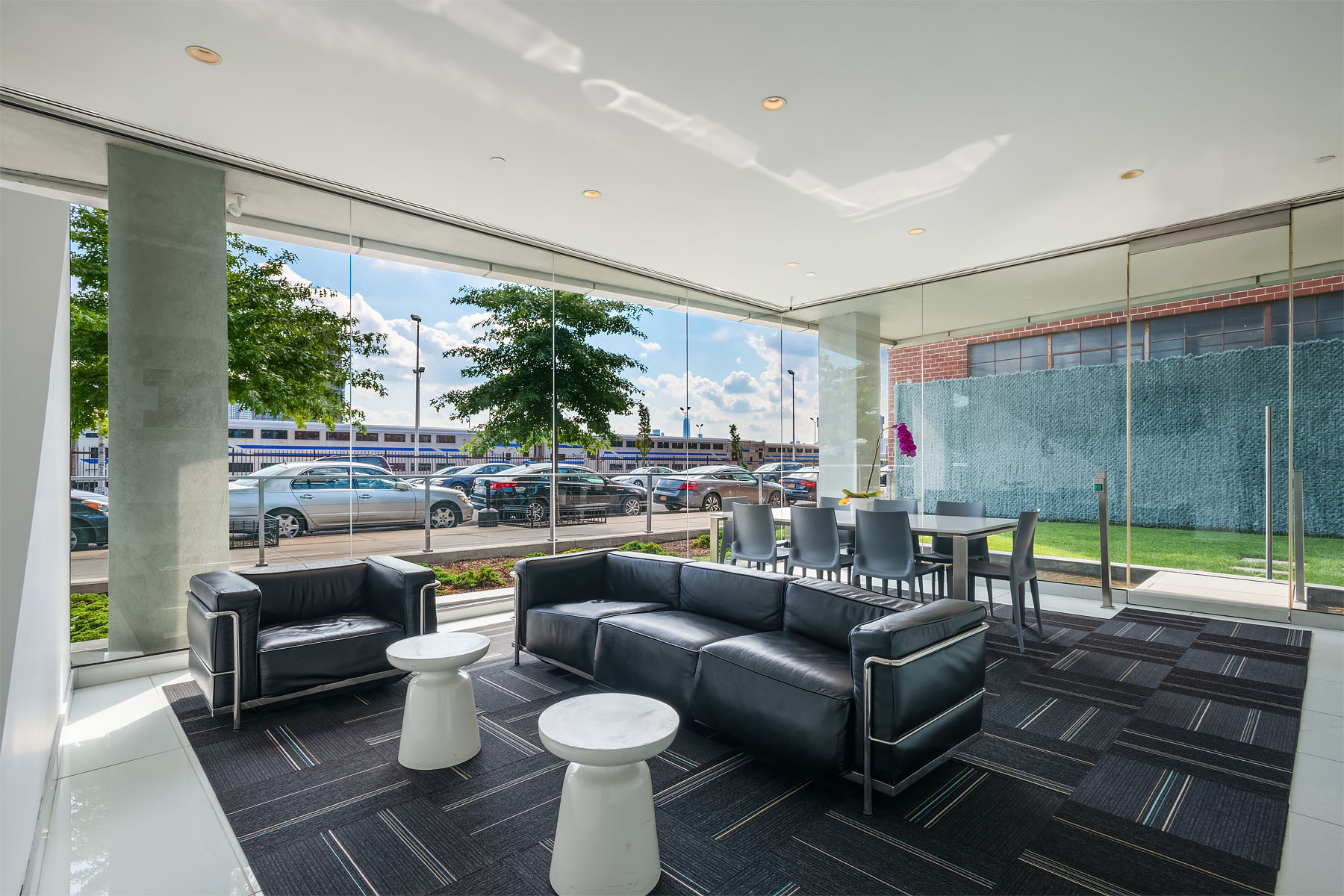 5-19 Borden Avenue, Unit 6C Queens, NY 11101 - Photo 9 of 11 a living room with patio furniture and a potted plant