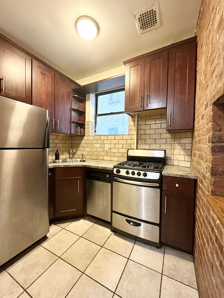 a kitchen with stainless steel appliances granite countertop a refrigerator stove and sink