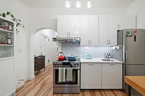 a kitchen with a sink cabinets and stainless steel appliances