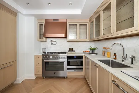 a kitchen with stainless steel appliances granite countertop a stove and a sink