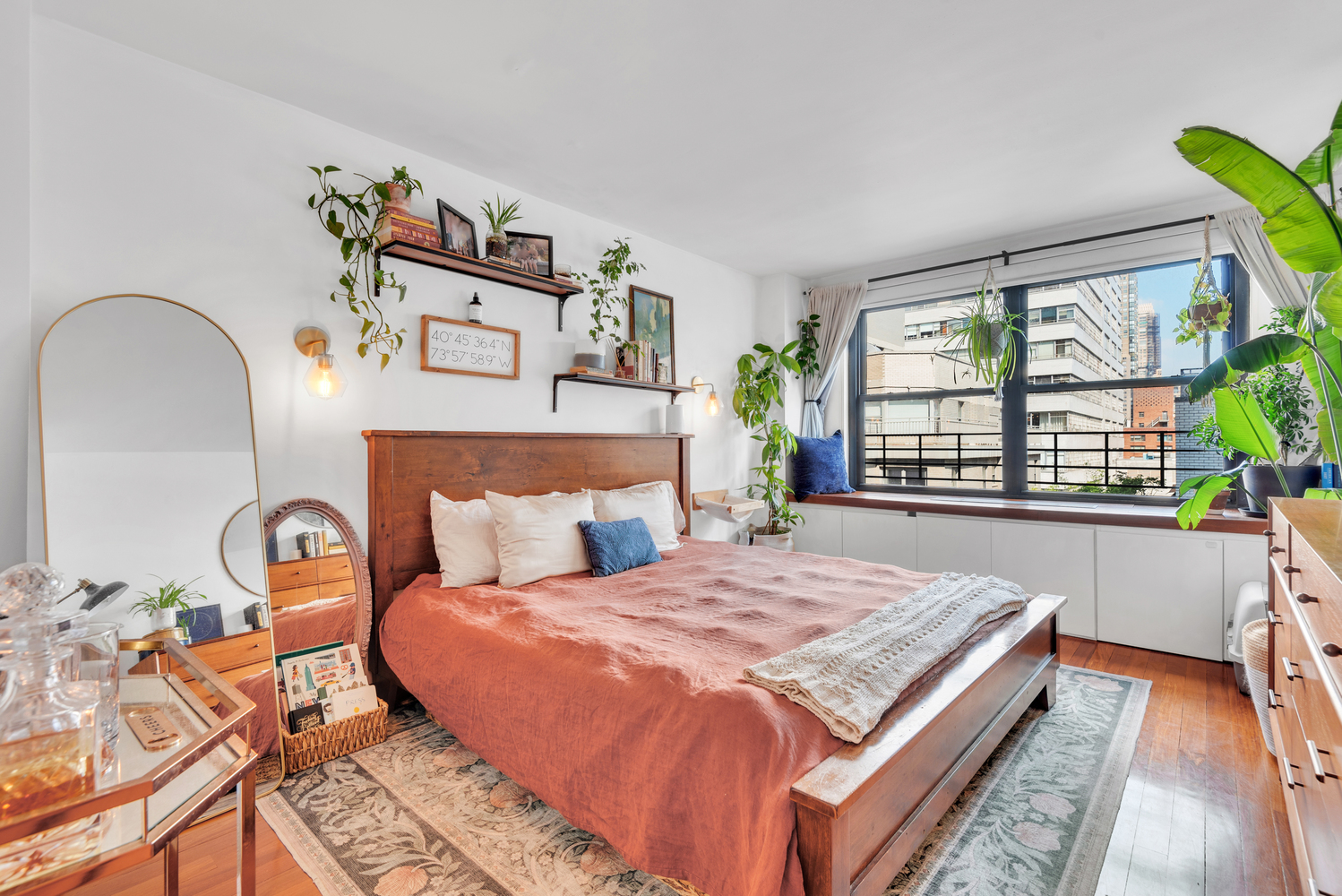 225 East 57th Street, Unit 14A Manhattan, NY 10022 - Photo 5 of 8 a bedroom with a bed and a large window with the outer view