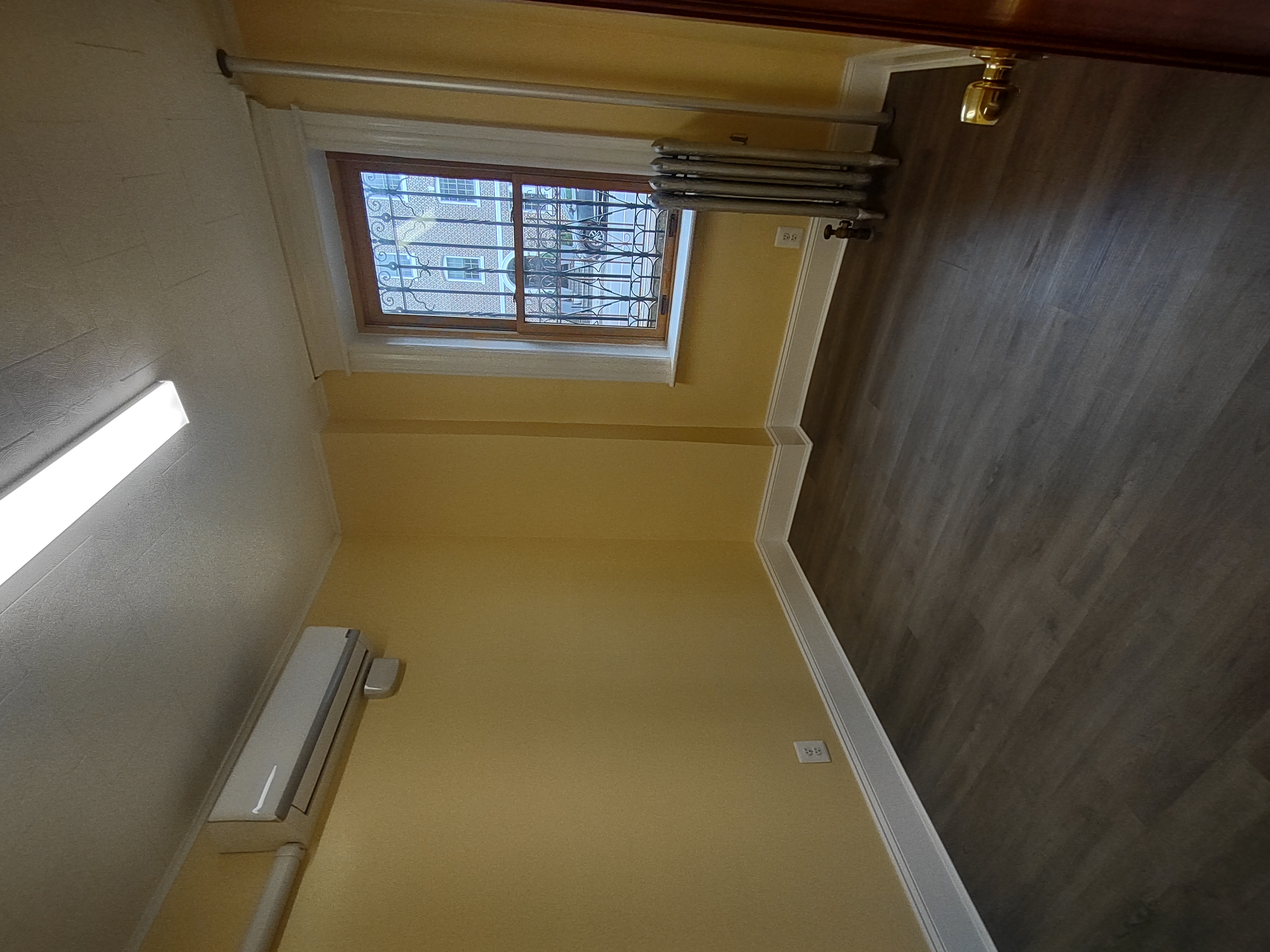 175 Fenimore Street Brooklyn, NY 11225 - Photo 7 of 11 an empty room with wooden floor and windows