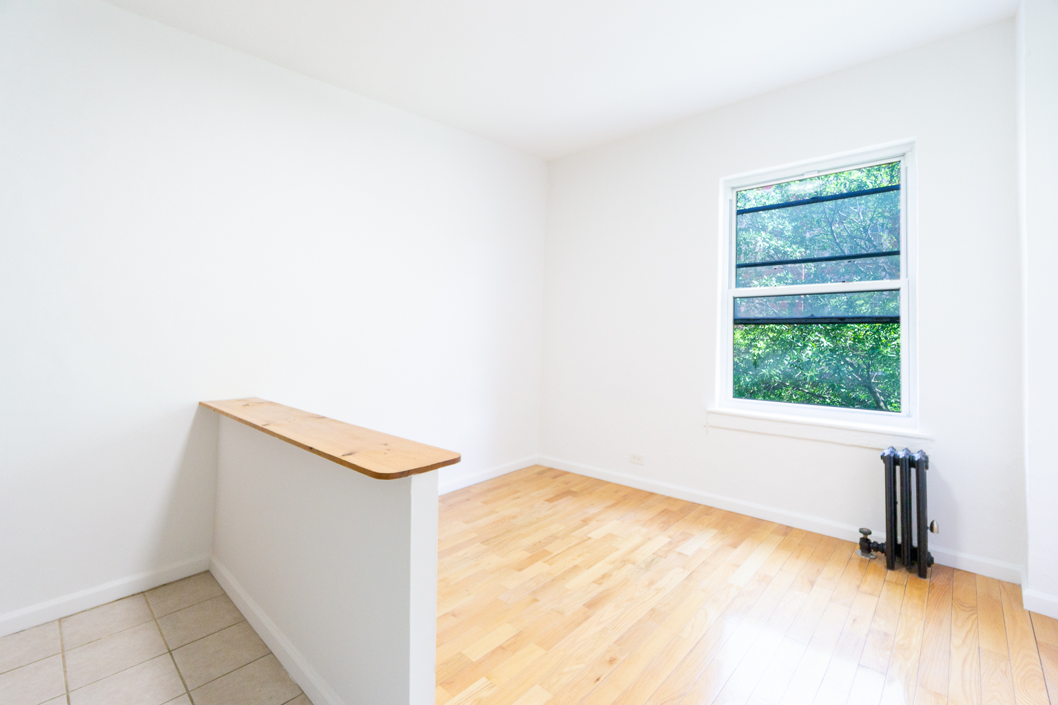 320 West 20th Street, Unit 15 Manhattan, NY 10011 - Photo 2 of 8 a view of empty room with wooden floor and fan