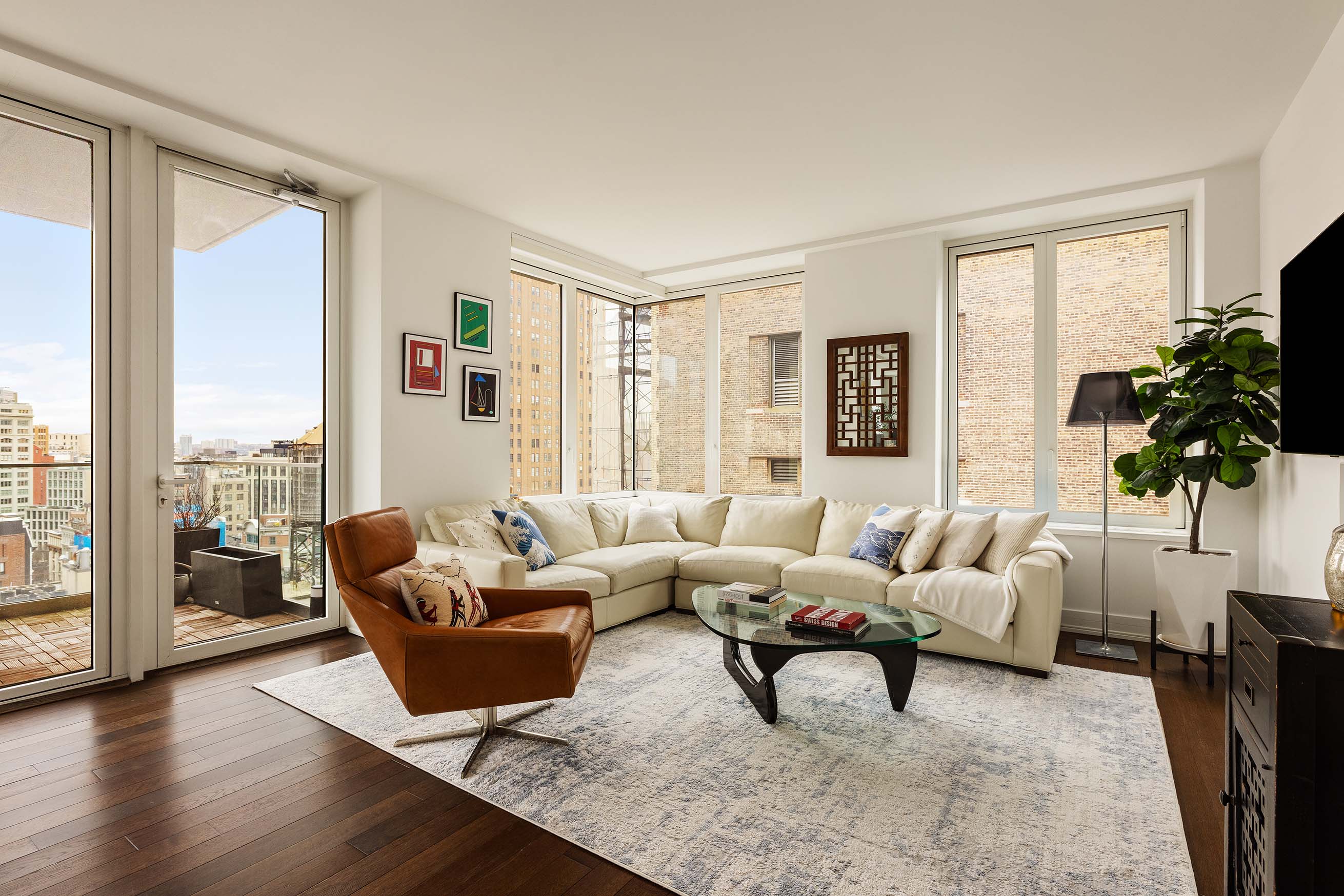 5 Franklin Place, Unit 14A Manhattan, NY 10013 - Photo 3 of 23 a living room with furniture potted plant and a large window