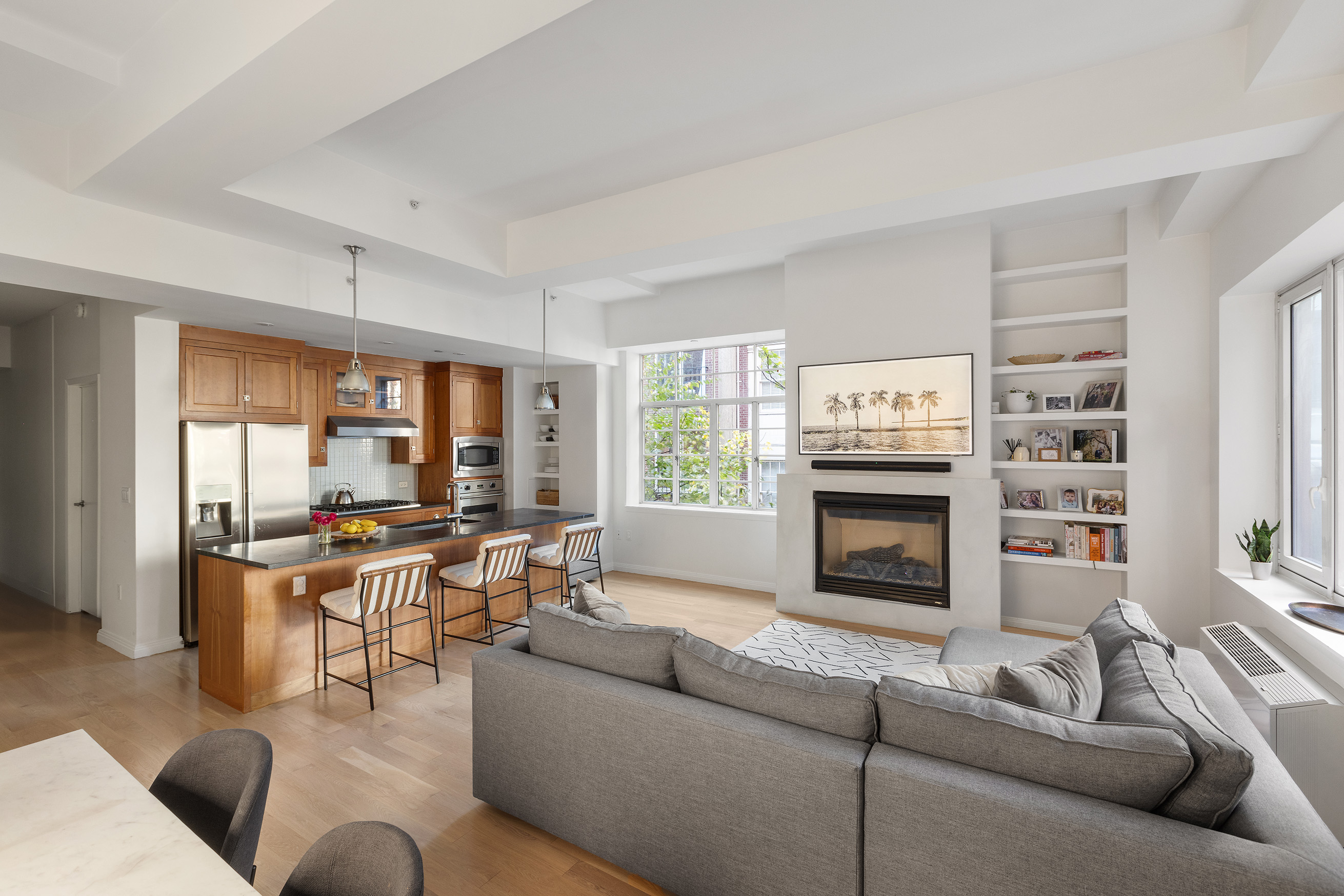 9 College Place, Unit 2K Brooklyn, NY 11201 - Photo 3 of 17 a living room with furniture a fireplace and a large window