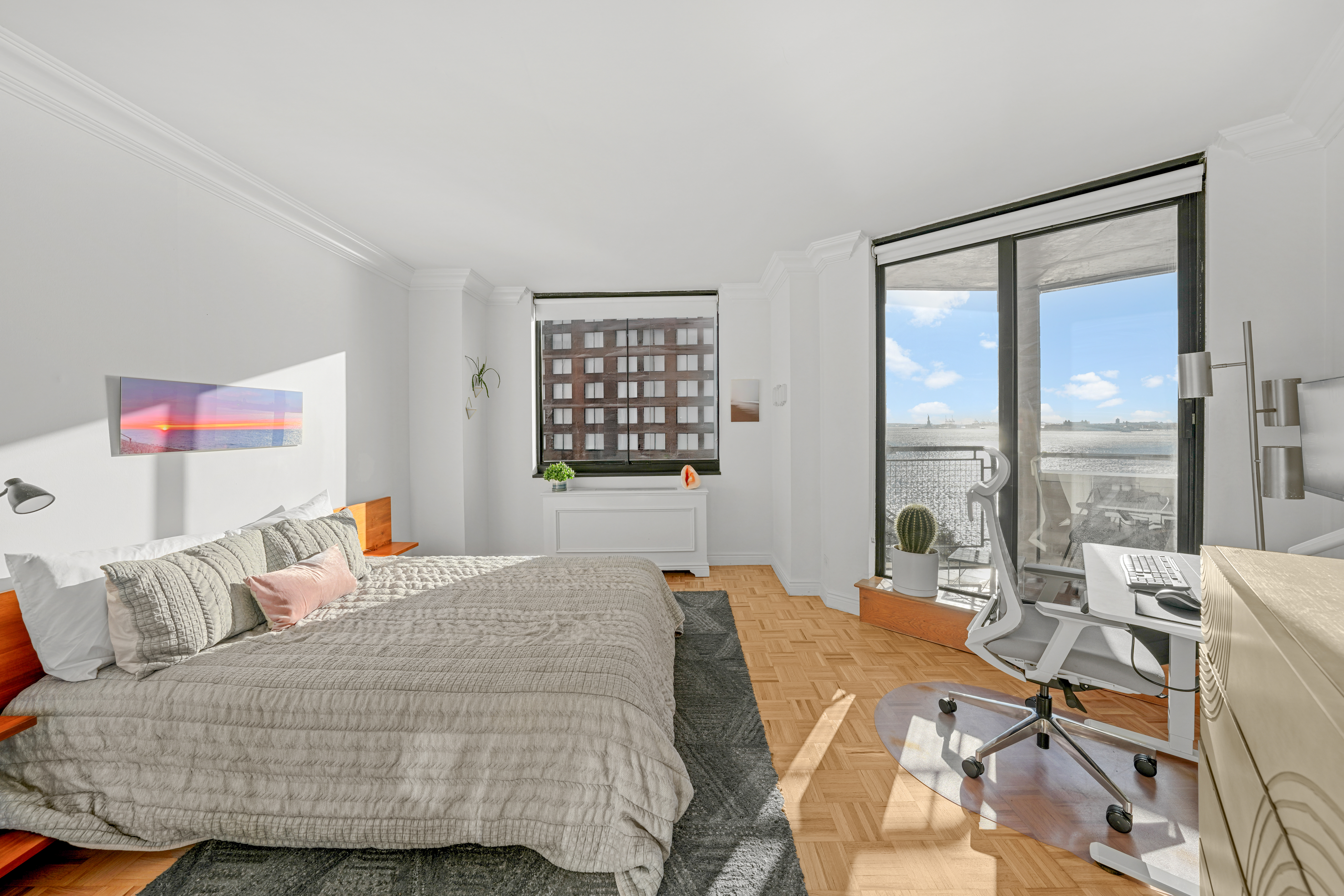 377 Rector Place, Unit 7K Manhattan, NY 10280 - Photo 5 of 11 a bedroom with a bed and a large window