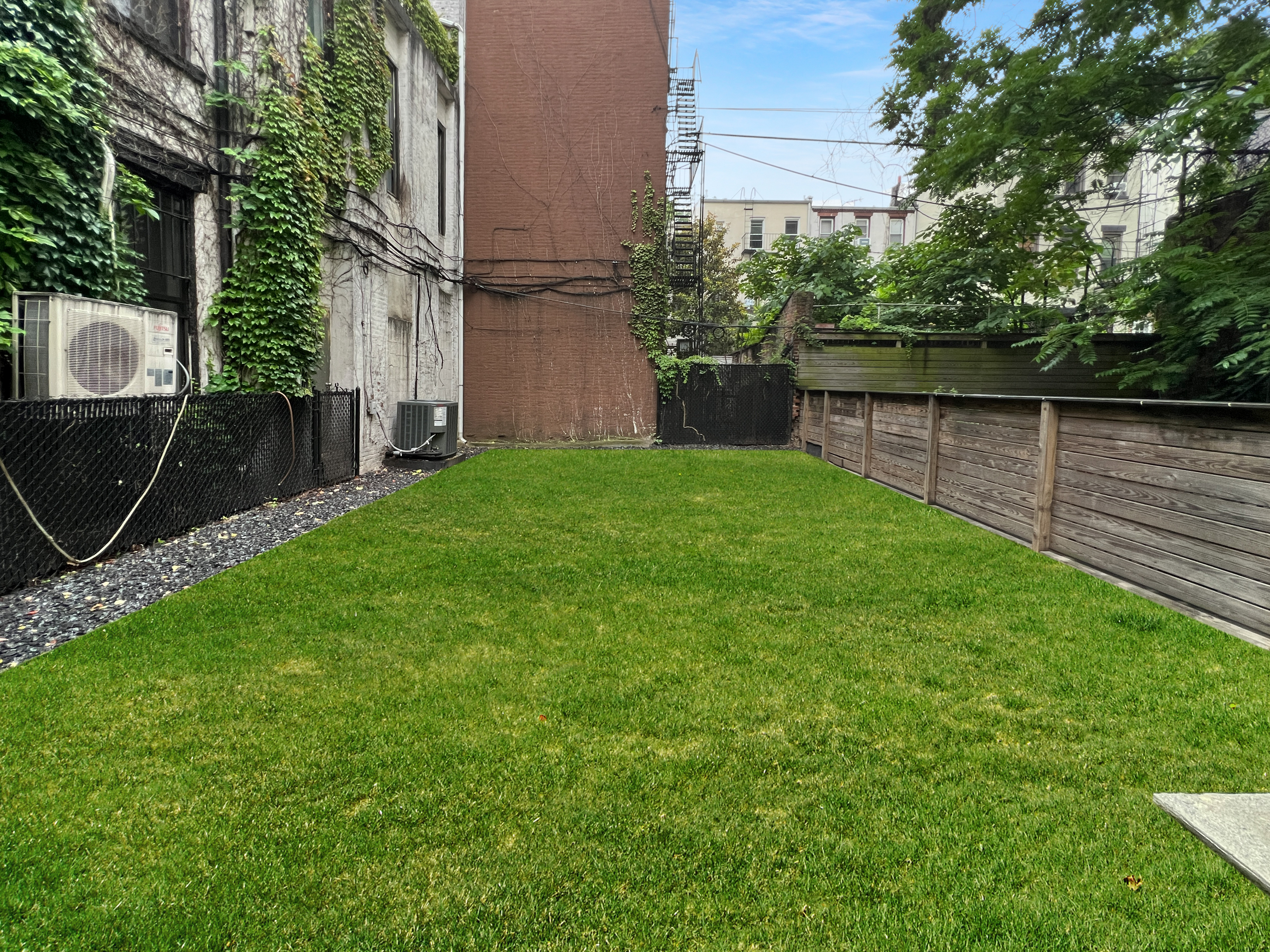 352 Degraw Street, Unit 1 Brooklyn, NY 11231 - Photo 17 of 20 a view of a backyard with plants and a slide