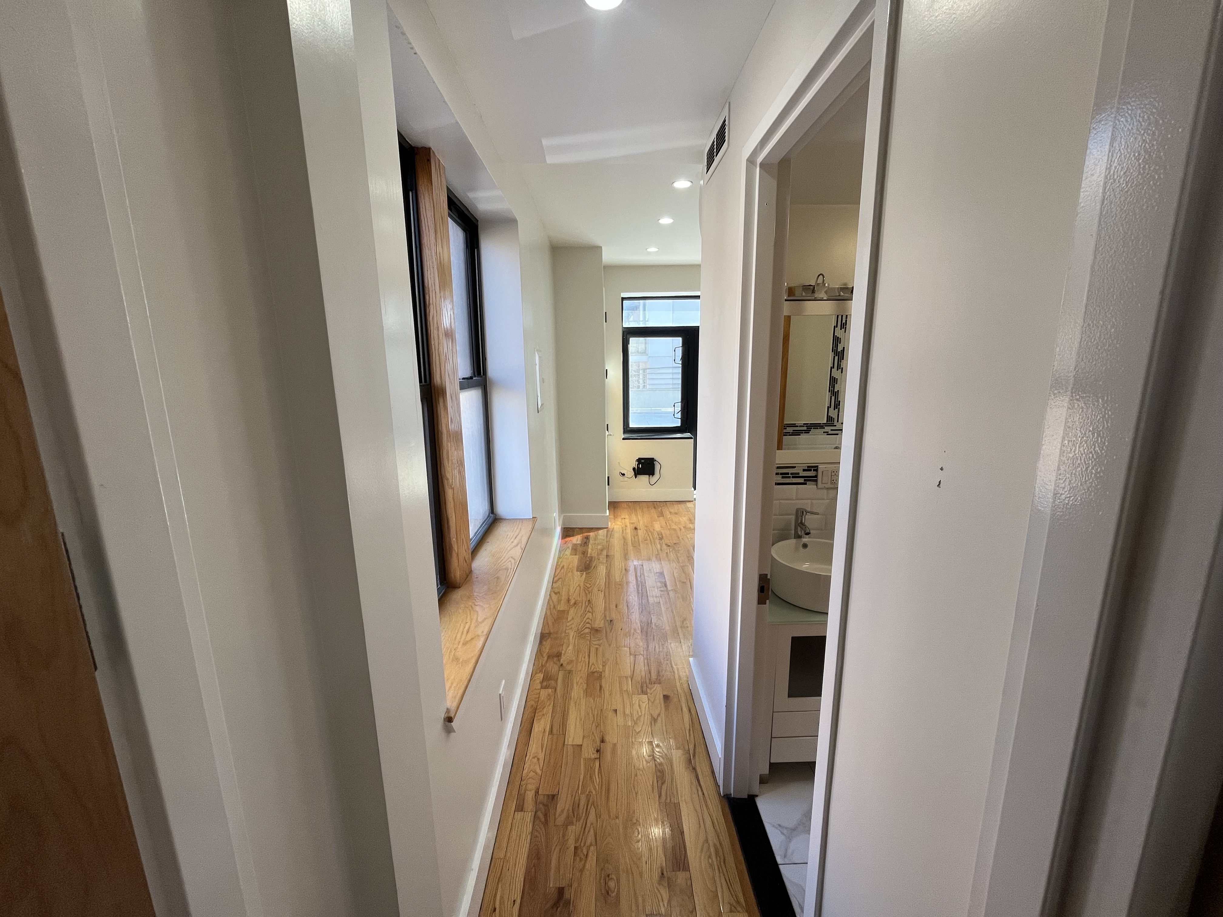 610 Monroe Street, Unit 2R Brooklyn, NY 11221 - Photo 5 of 6 a view of hallway with wooden floor