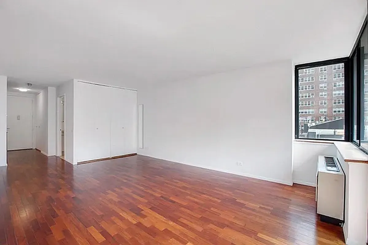 330 East 75th Street, Unit 4D Manhattan, NY 10021 - Photo 3 of 9 a view of an empty room with wooden floor and a window
