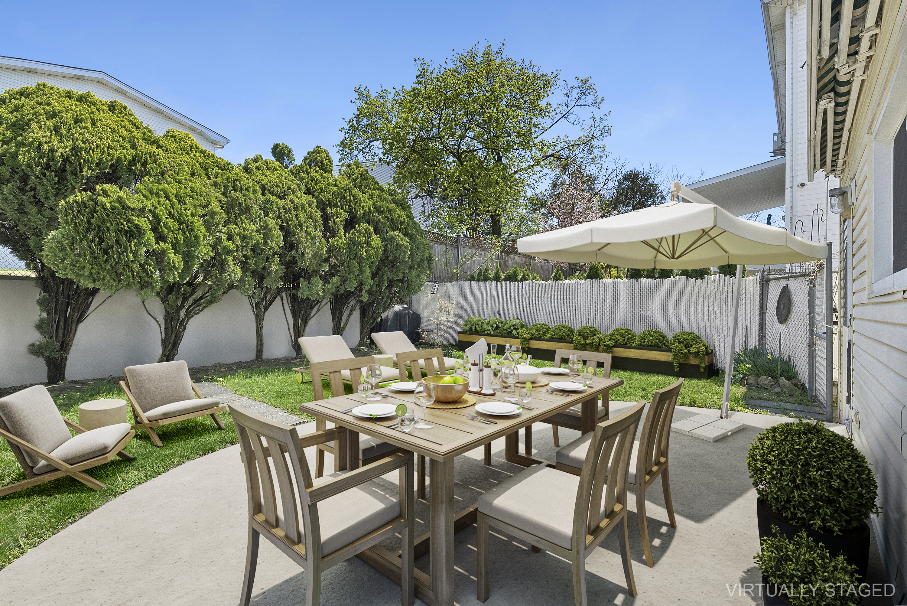 29 Athena Place Staten Island, NY 10314 - Photo 8 of 10 a view of a patio with a table and chairs under an umbrella