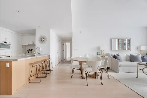 a living room with furniture a dining table and kitchen view