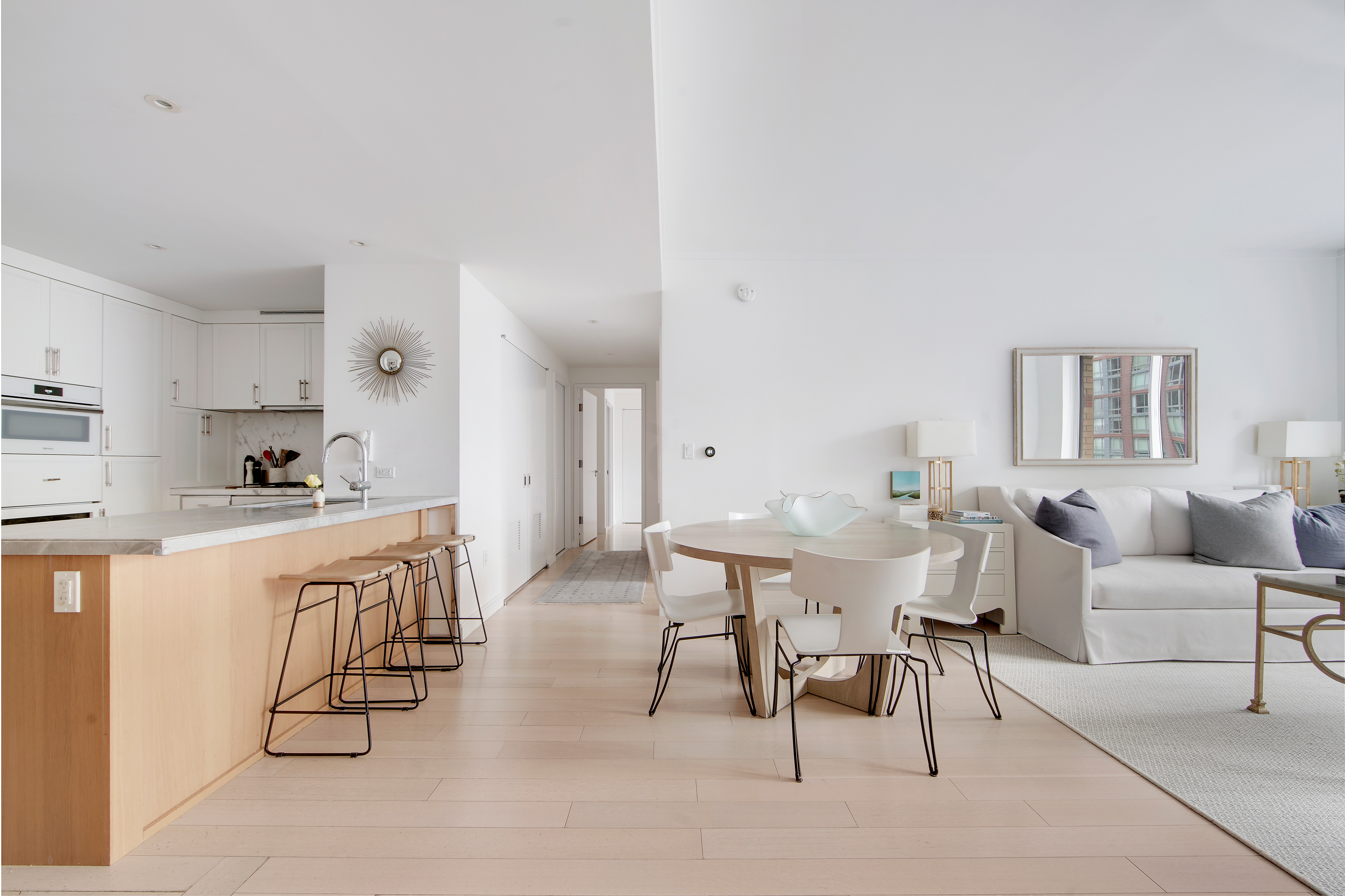 a living room with furniture a dining table and kitchen view