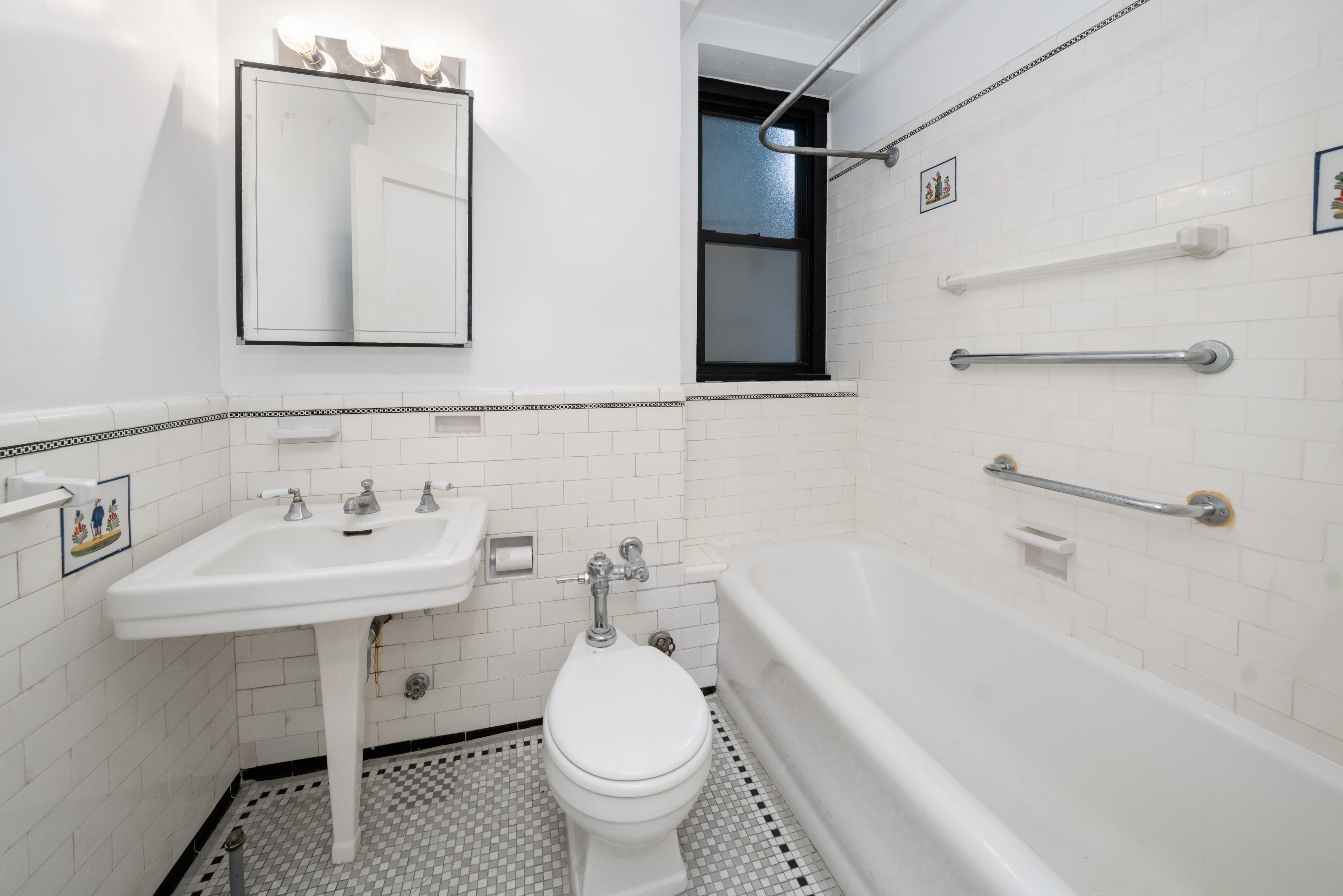 235 East 22nd Street, Unit 2R Manhattan, NY 10010 - Photo 7 of 15 a bathroom with a sink toilet and mirror