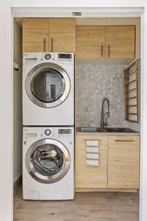 a utility room with sink dryer and washer