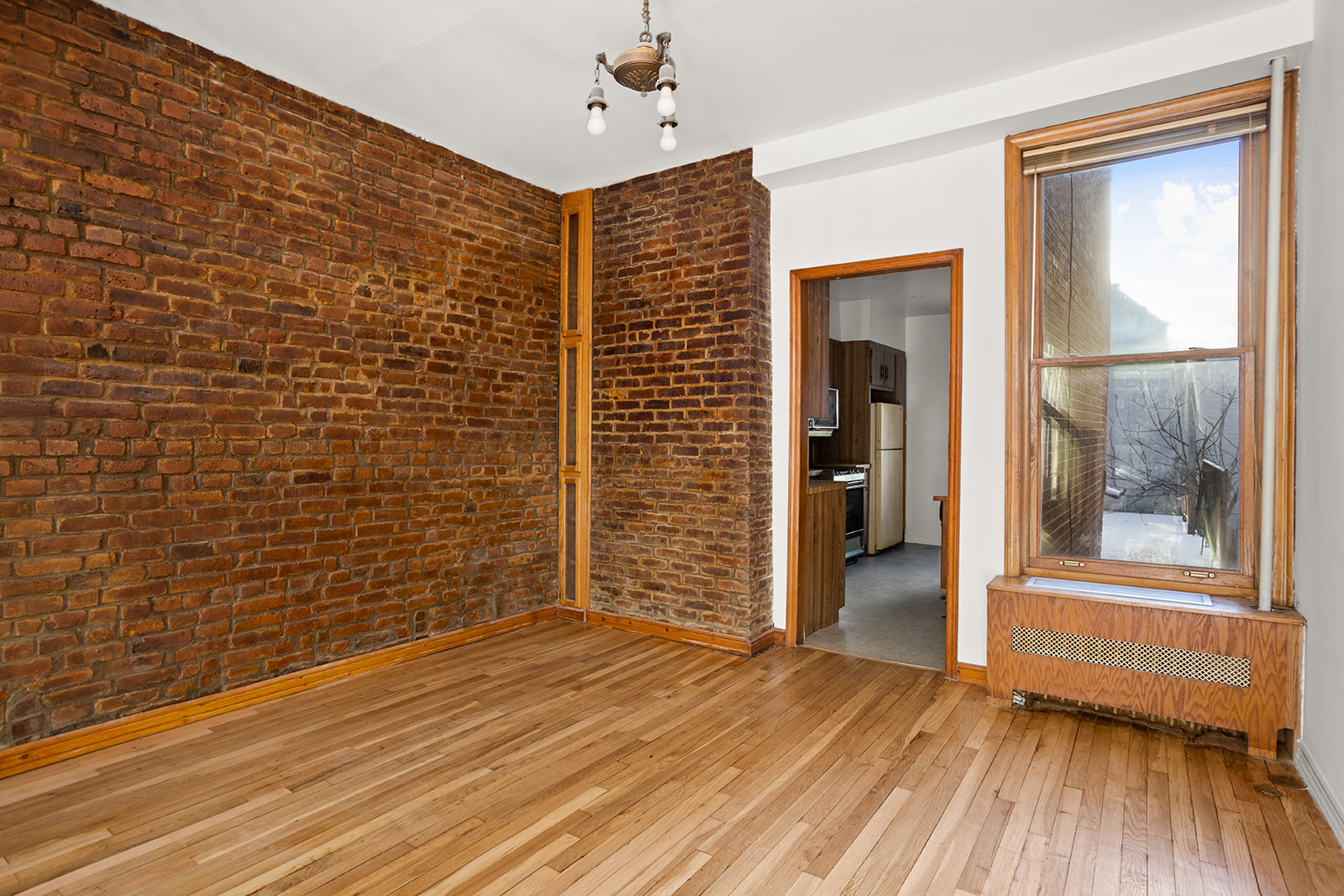 1682 8th Avenue Brooklyn, NY 11215 - Photo 7 of 16 a view of interior space with wooden floor and brick wall