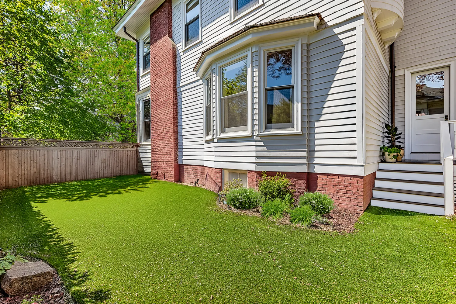 a street view with wooden fence and flowers
